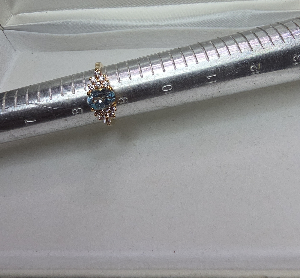 Gold Ring with Blue Center Stone and Accent Diamonds